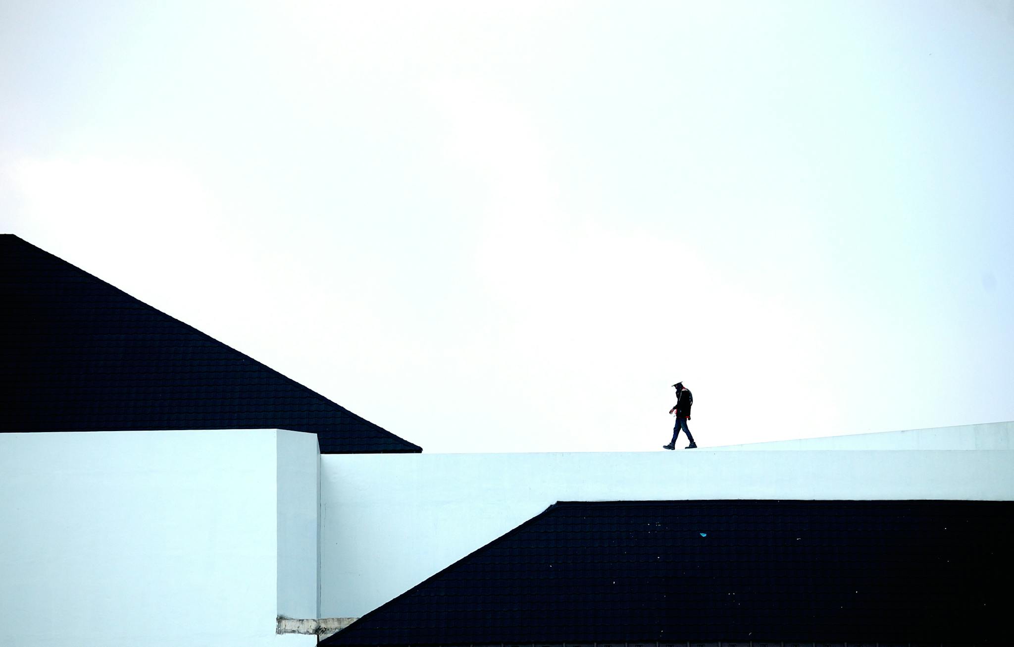 Man Walking on White Platform